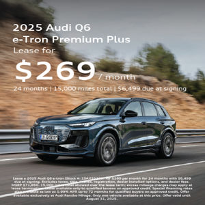 2025 Audi Q6 e-tron driving at an angle view